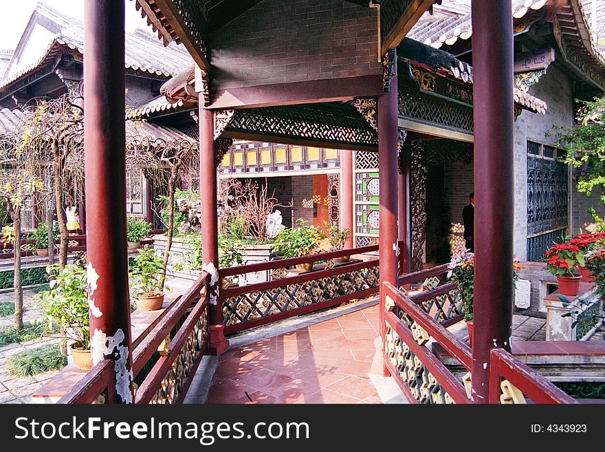 Chinese Ancient Garden Corridor,roofed Corridor with round columns and railings.A classic wood architechture in Qinghui Garden,Shunde,Guangdong,China, which is one of the Four Famous Garden of Guangdong.