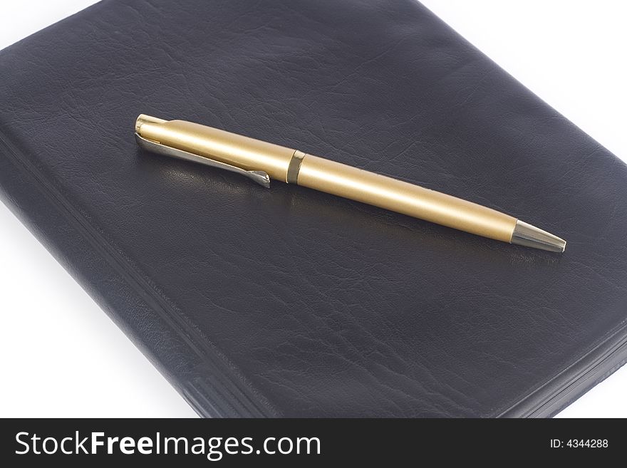 Leather notebook with pen isolated over white background