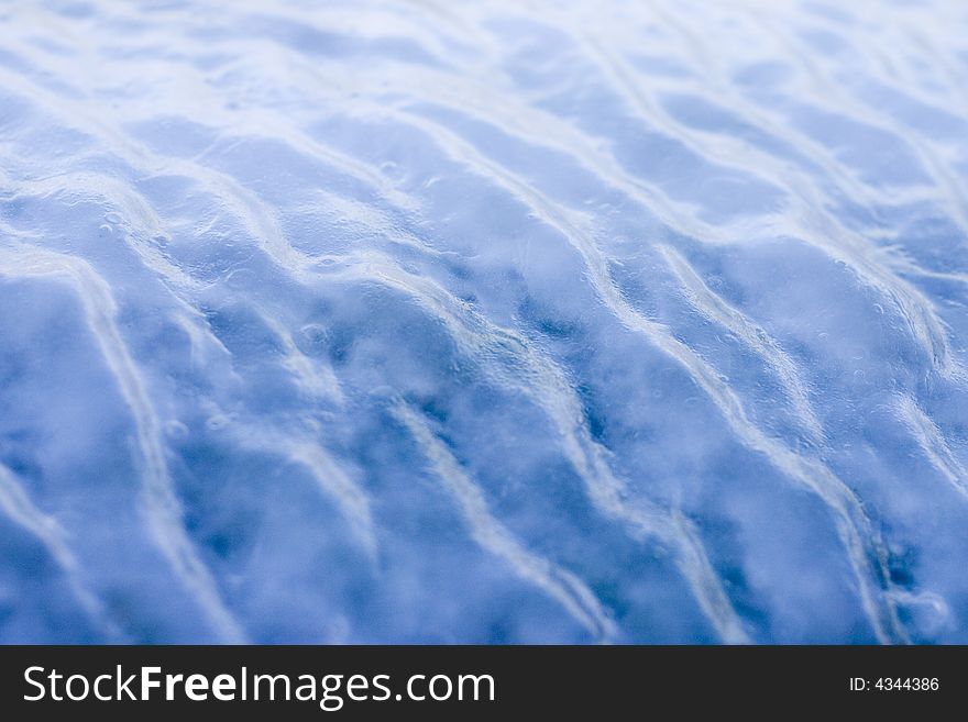 Blue ice with waves on the surface. Blue ice with waves on the surface