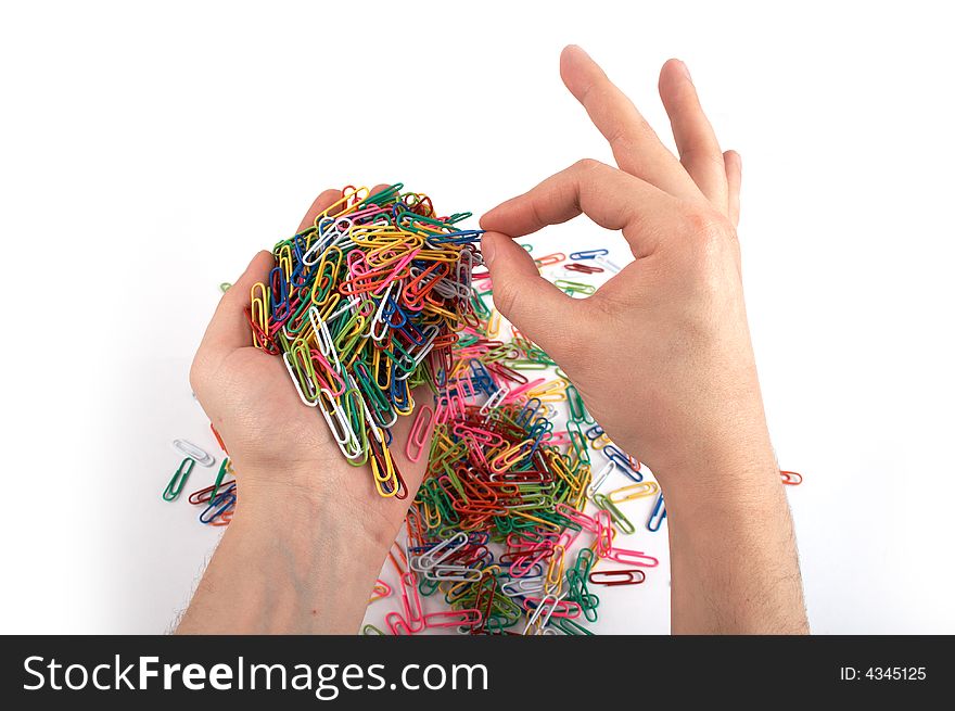 Hands holds paper clips picking one isolated on white