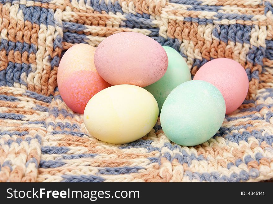 Colorful pastel Easter eggs on handmade crocheted blanket background. Colorful pastel Easter eggs on handmade crocheted blanket background.