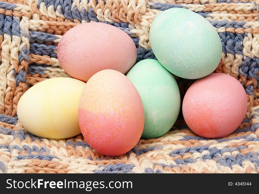 Colorful pastel Easter eggs on handmade crocheted blanket background. Colorful pastel Easter eggs on handmade crocheted blanket background.