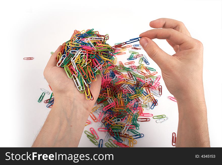 Hands holds paper clips picking chain isolated on white