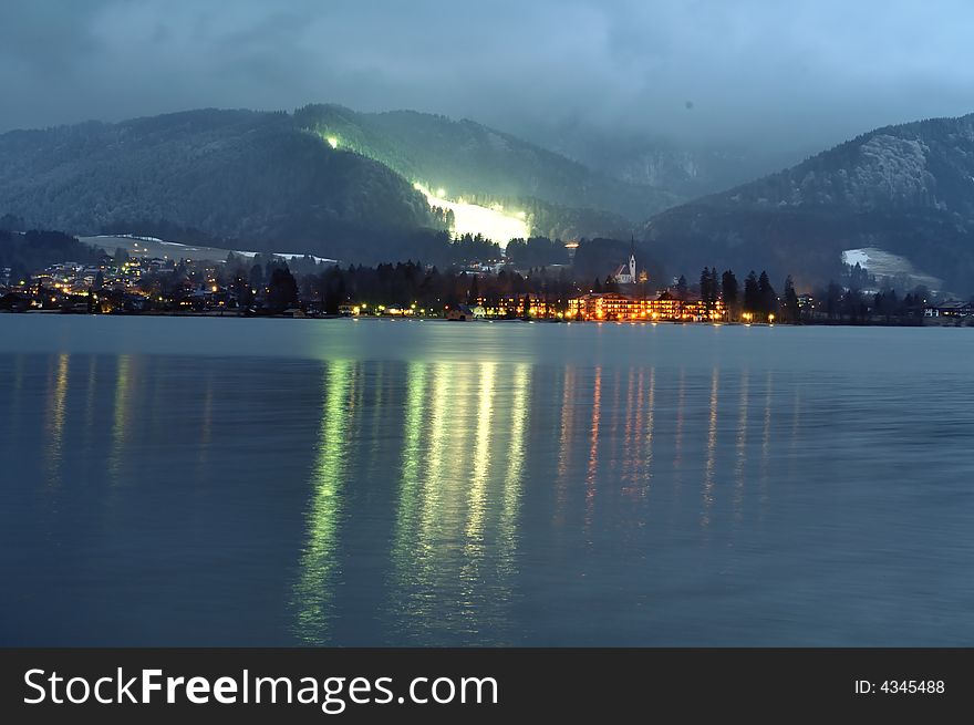 A night scene at a german lake with a ski area in the background. A night scene at a german lake with a ski area in the background