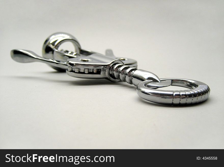 A classic domestic corkscrew on a neutral grey background