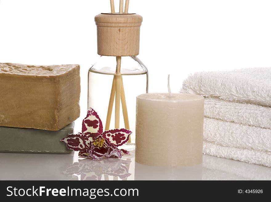 Aroma therapy objects. bottle of esential oil, candle, towels, soap, orchid