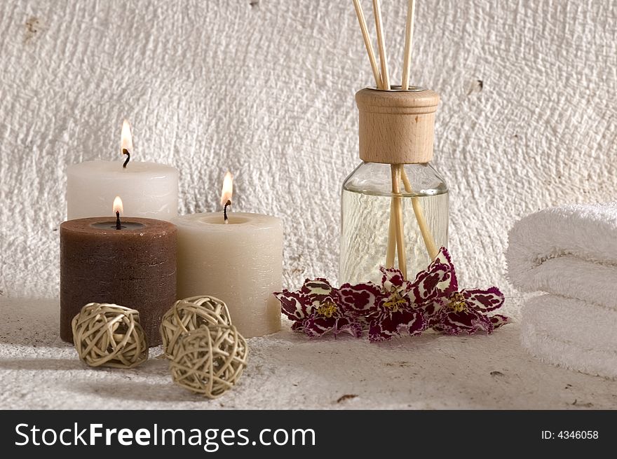 Aroma therapy objects. bottle of esential oil, candles, bath-salt, towels, orchid