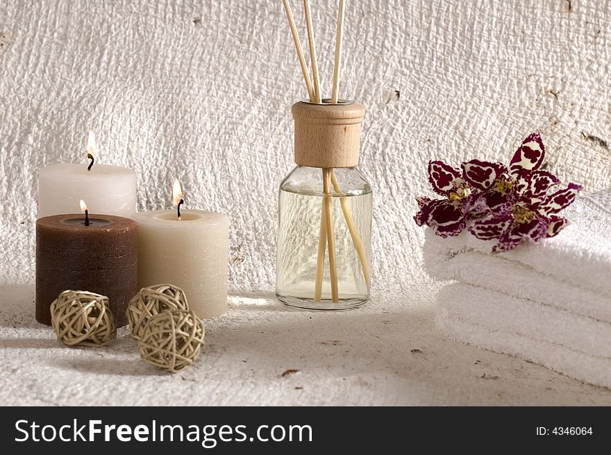 Aroma therapy objects. bottle of esential oil, candles, bath-salt, towels, orchid