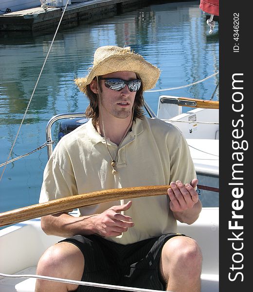 Young confident man smiling boat marina hat and sunglasses on. Young confident man smiling boat marina hat and sunglasses on