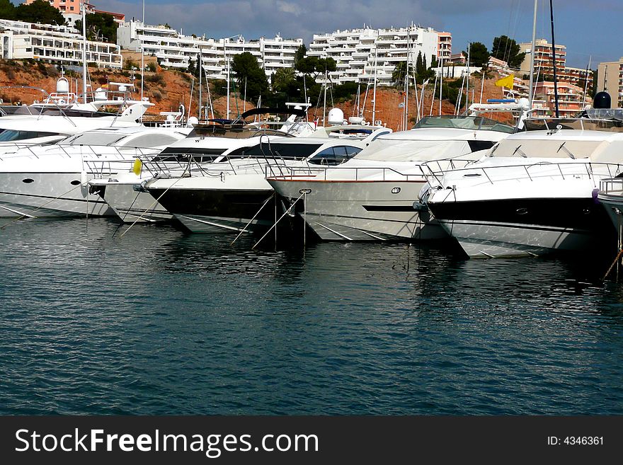 Row of boats and luxury yachts in a Marina. Row of boats and luxury yachts in a Marina