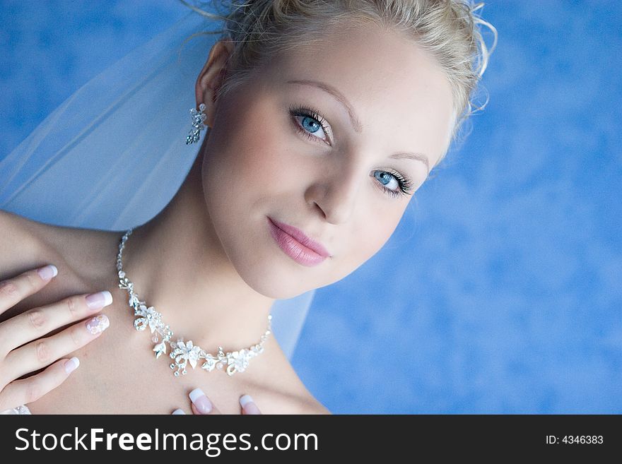 A bride puts on a necklace. A bride puts on a necklace