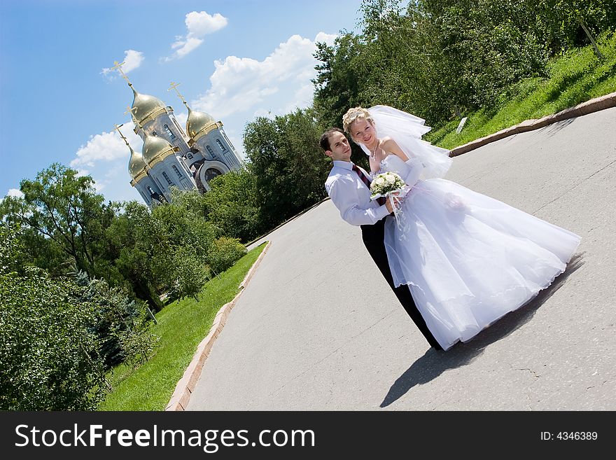 Newly married couple in a road near the church. Newly married couple in a road near the church