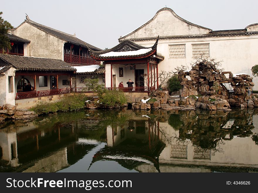 A pavilion with it's beautiful surroundings and their reflection in the water.This picture is taken in Net lion park in Suzhou ,China.