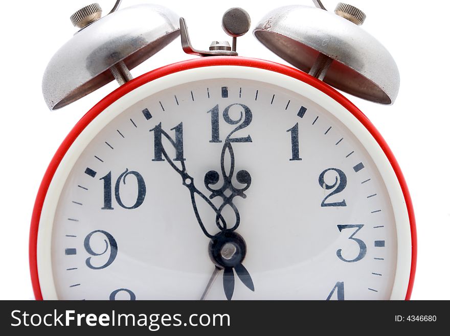 Old red alarm clock on a white background