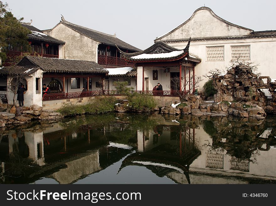 A pavilion with it's beautiful surroundings and their reflection in the water.This picture is taken in Net lion park in Suzhou ,China.