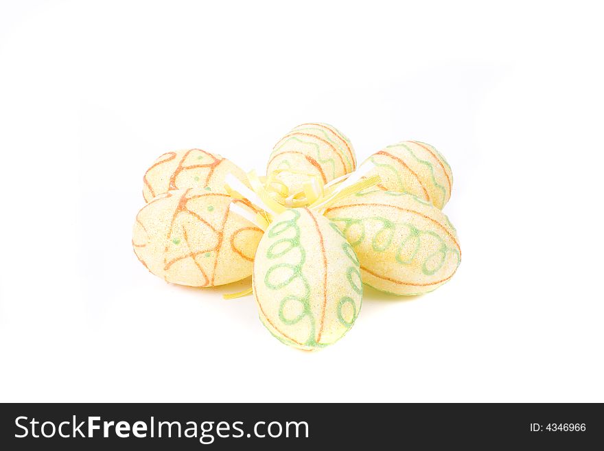Yellow painted easter eggs on white background