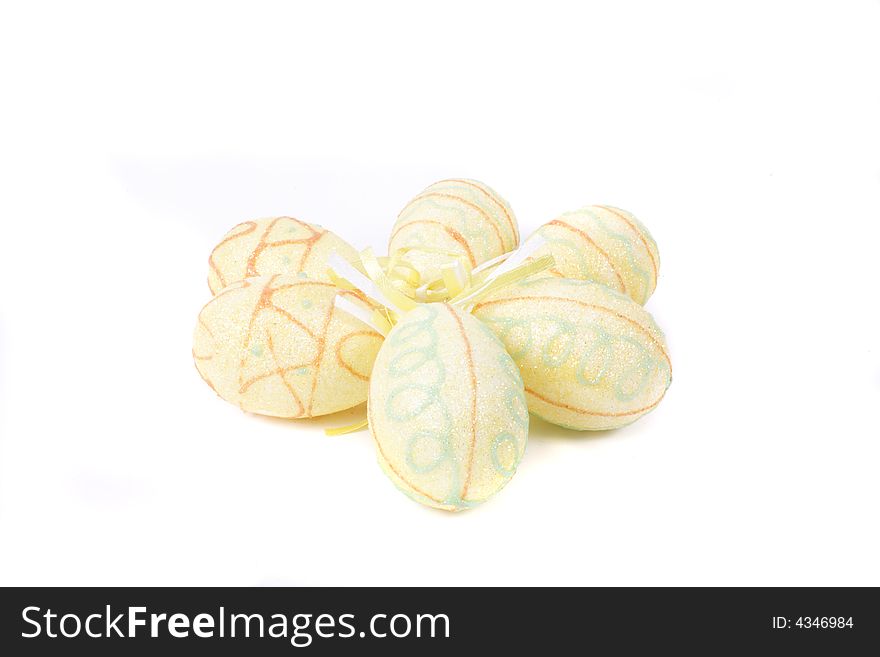 Yellow painted easter eggs on white background