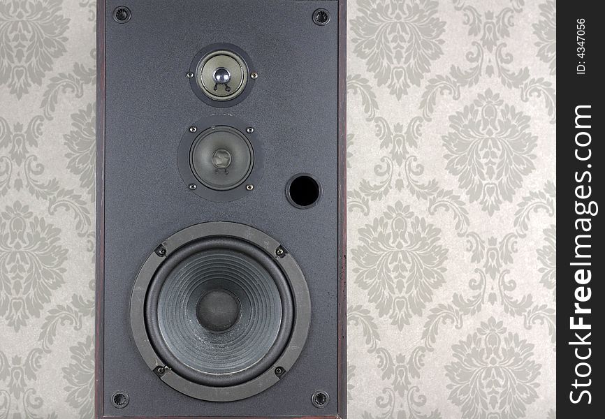 Audio speaker against grey wallpaper