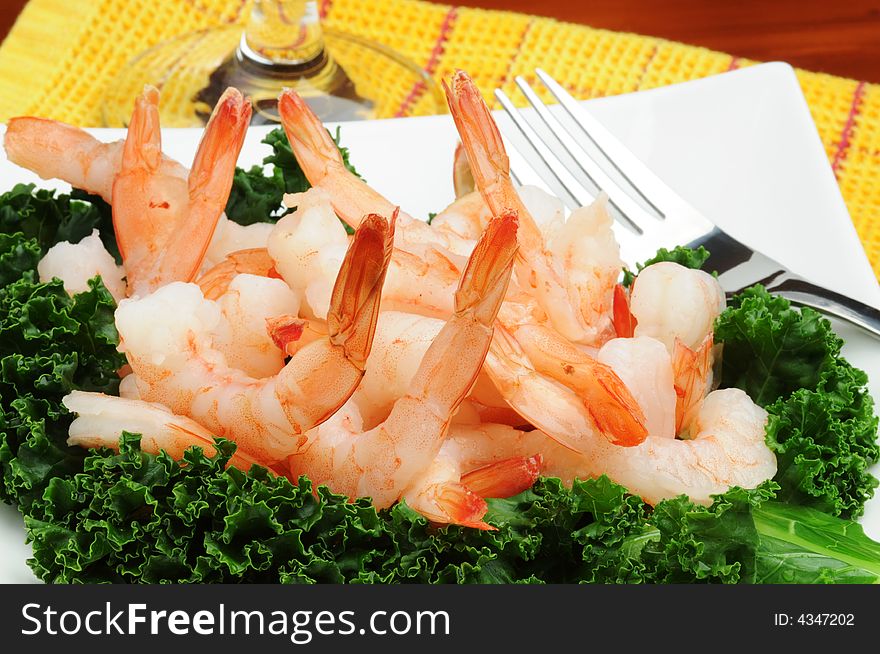 Tasty shrimp salad served on a bed of greens.