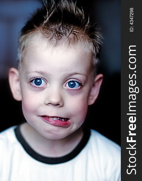 Child with big blue eyes in a T-shirt
