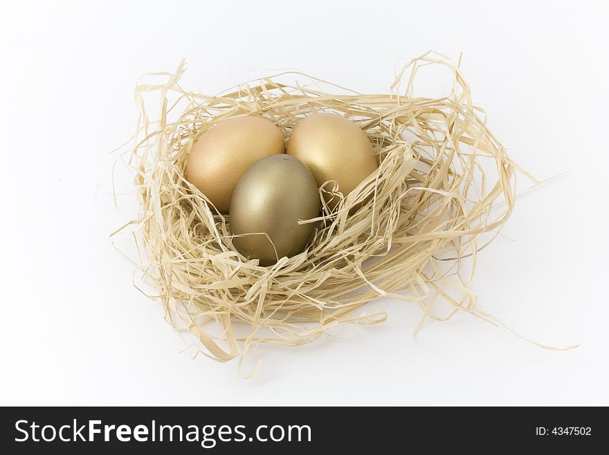 Golden and bronze eggs in a nest