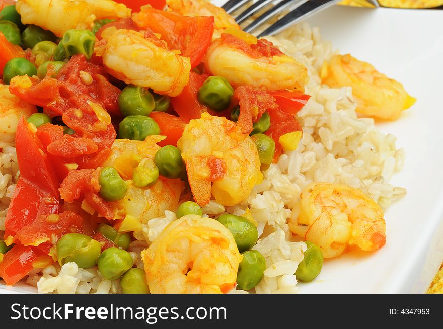 Shrimp infused with saffron served over rice. Shrimp infused with saffron served over rice.