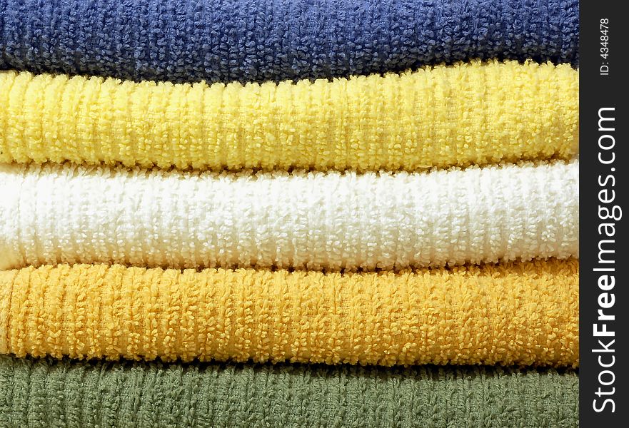 A group of colorful stacked cotton towels