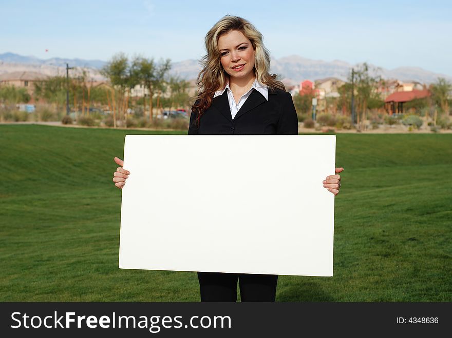 Portrait of a confident and successful businesswoman holding blank board. Portrait of a confident and successful businesswoman holding blank board