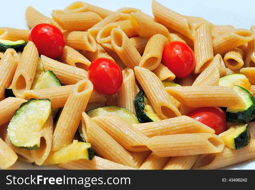 Still life photo of a plate of whole wheat pasta with summertime ingredients. Still life photo of a plate of whole wheat pasta with summertime ingredients