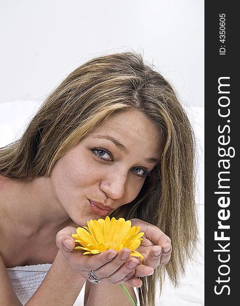 Girl holding a yellow flower in her hand