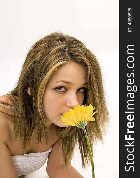 Girl holding a yellow flower in her hand. Girl holding a yellow flower in her hand