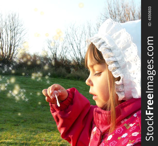 A little girl blowing bubbles