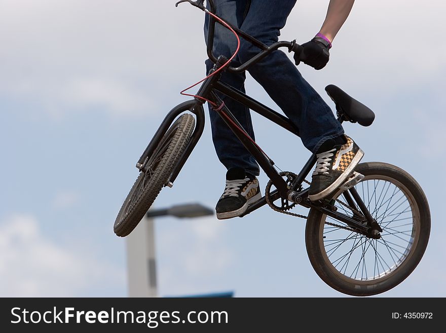 A BMX (Bicycle Moto-cross(X)) in the air against the sky. A BMX (Bicycle Moto-cross(X)) in the air against the sky
