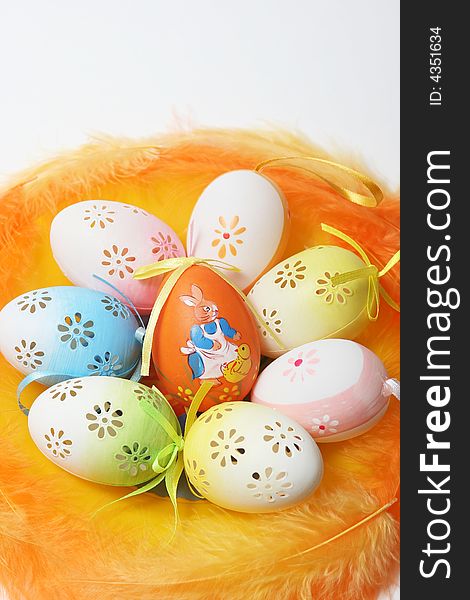 Easter eggs with yellow and orange feathers.