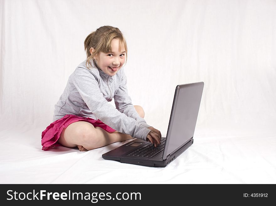 Checky young girl playing on laptop