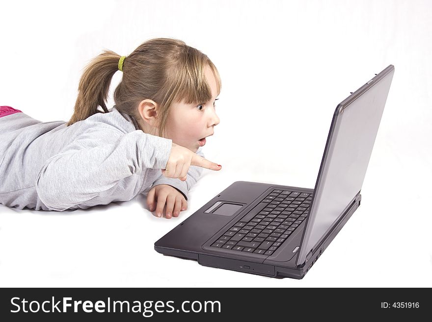 Young girl suprized playing on laptop. Young girl suprized playing on laptop