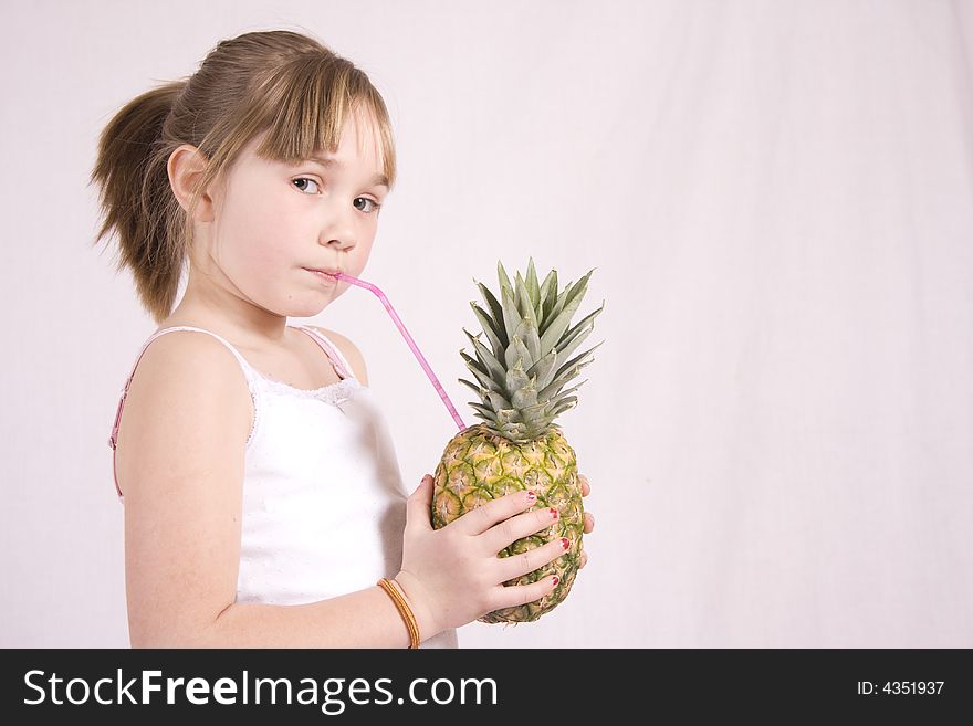 Young girl drinking from a pineapple. Young girl drinking from a pineapple