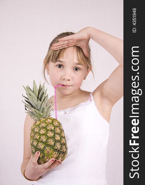 Young girl drinking from a pineapple. Young girl drinking from a pineapple