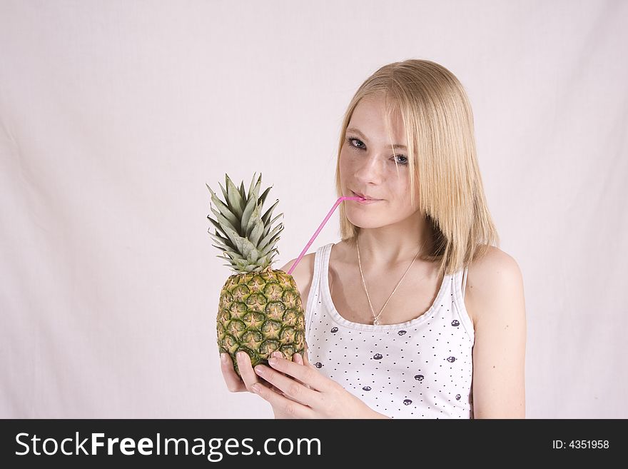 Teen drinking from a pineapple. Teen drinking from a pineapple