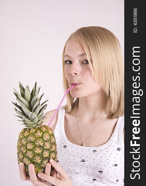 Closeup of teenager drinking from a pineapple. Closeup of teenager drinking from a pineapple