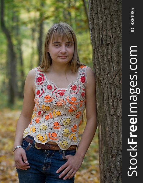 Portrait of the beautiful girl in autumn forest.