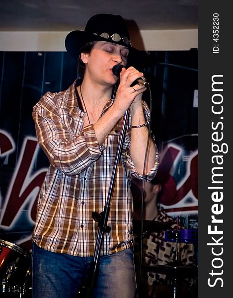 Singer with a microphone.  Concert of group StockDog in club the Woman-ljuba. Rostov-on-Don. Russia