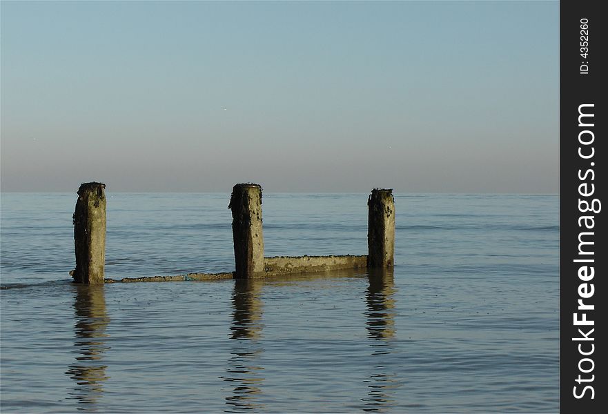 Groyne with incoming tide in the winter sun. Groyne with incoming tide in the winter sun