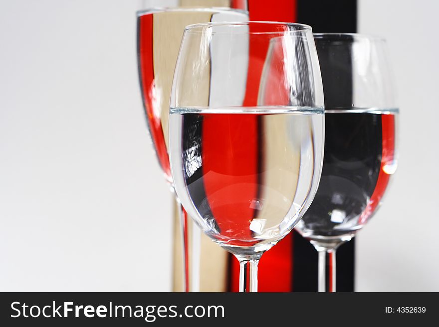 Champagne glasses detail against a color stripe background. Champagne glasses detail against a color stripe background