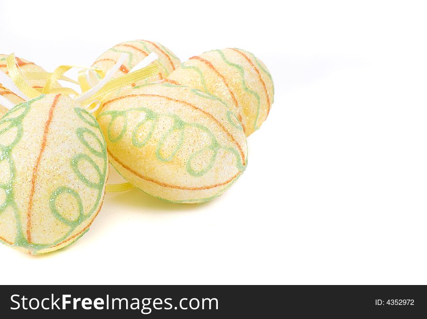 Yellow painted easter eggs on white background