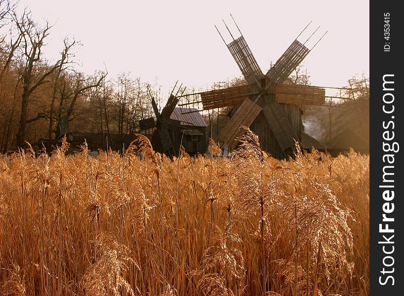 An old mill in a field. An old mill in a field