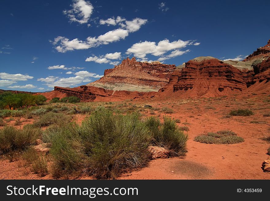 View of the red rock formations in Capitol Reef National Park with blue skyï¿½s and clouds. View of the red rock formations in Capitol Reef National Park with blue skyï¿½s and clouds