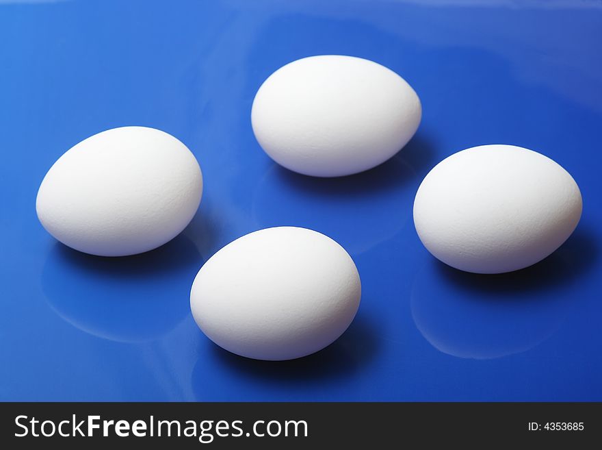 White eggs on blue background. White eggs on blue background.