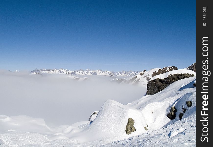 On the top of a mountain above the clouds seem to be in paradise