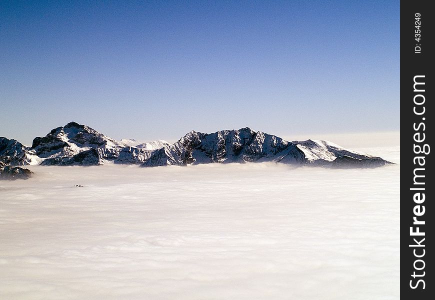 On the top of a mountain above the clouds seem to be in paradise